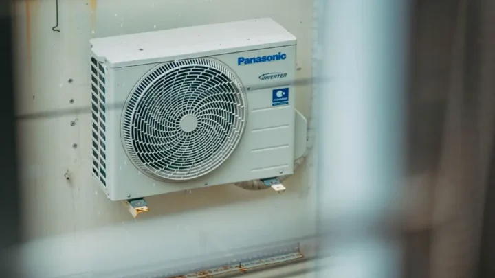 Air conditioner unit mounted outdoors on a building wall