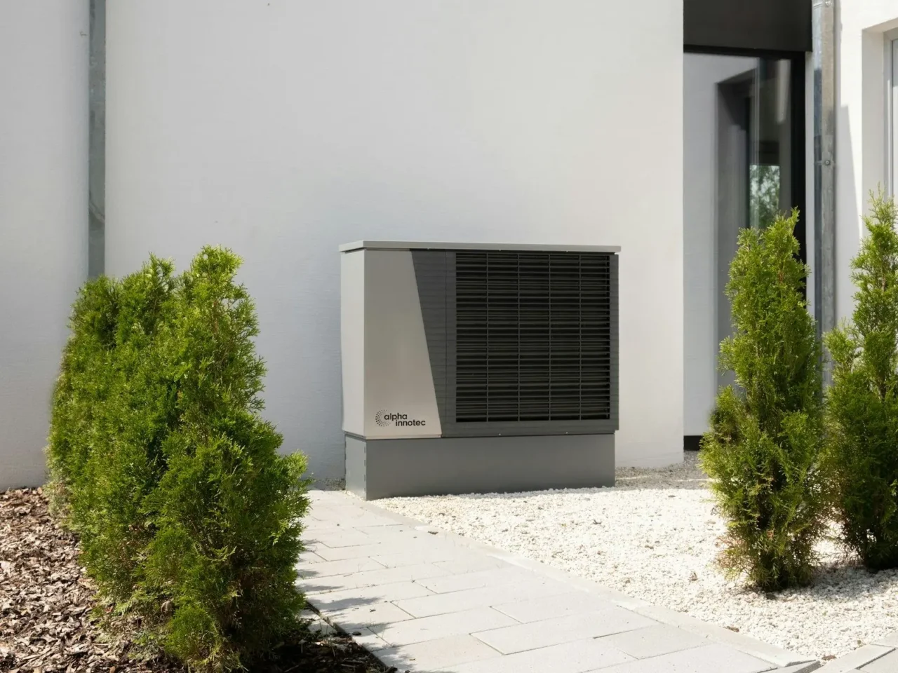Air conditioner outdoor unit beside a house