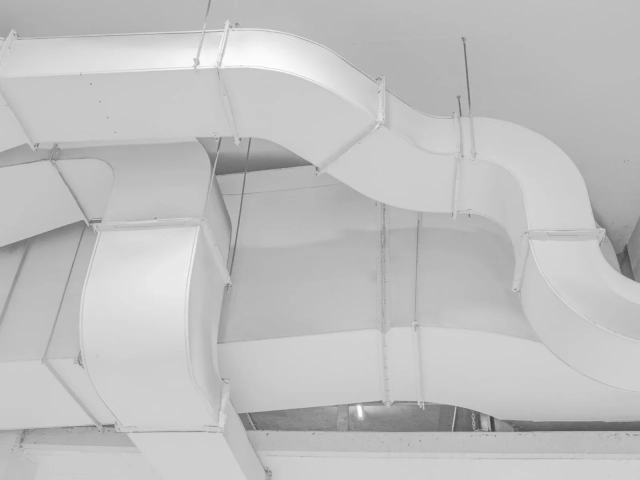 Sheet metal air ducts running along a ceiling