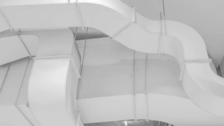 Sheet metal air ducts running along a ceiling
