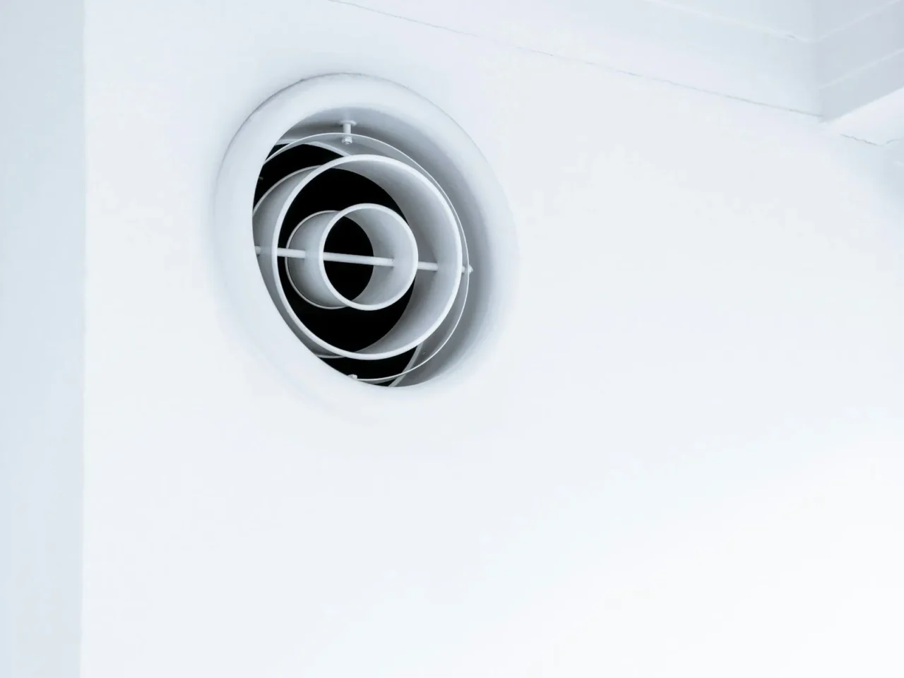 Round ceiling air vent in a white ceiling