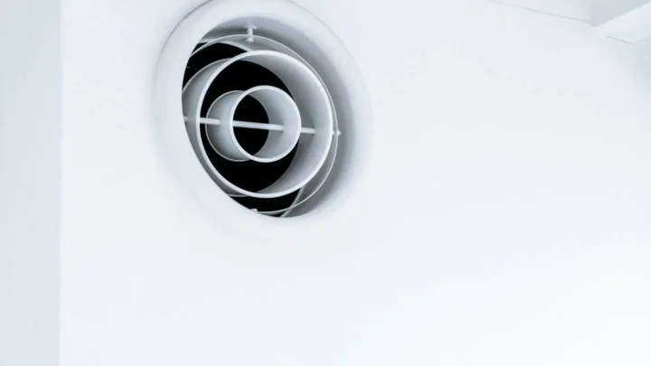 Round ceiling air vent in a white ceiling