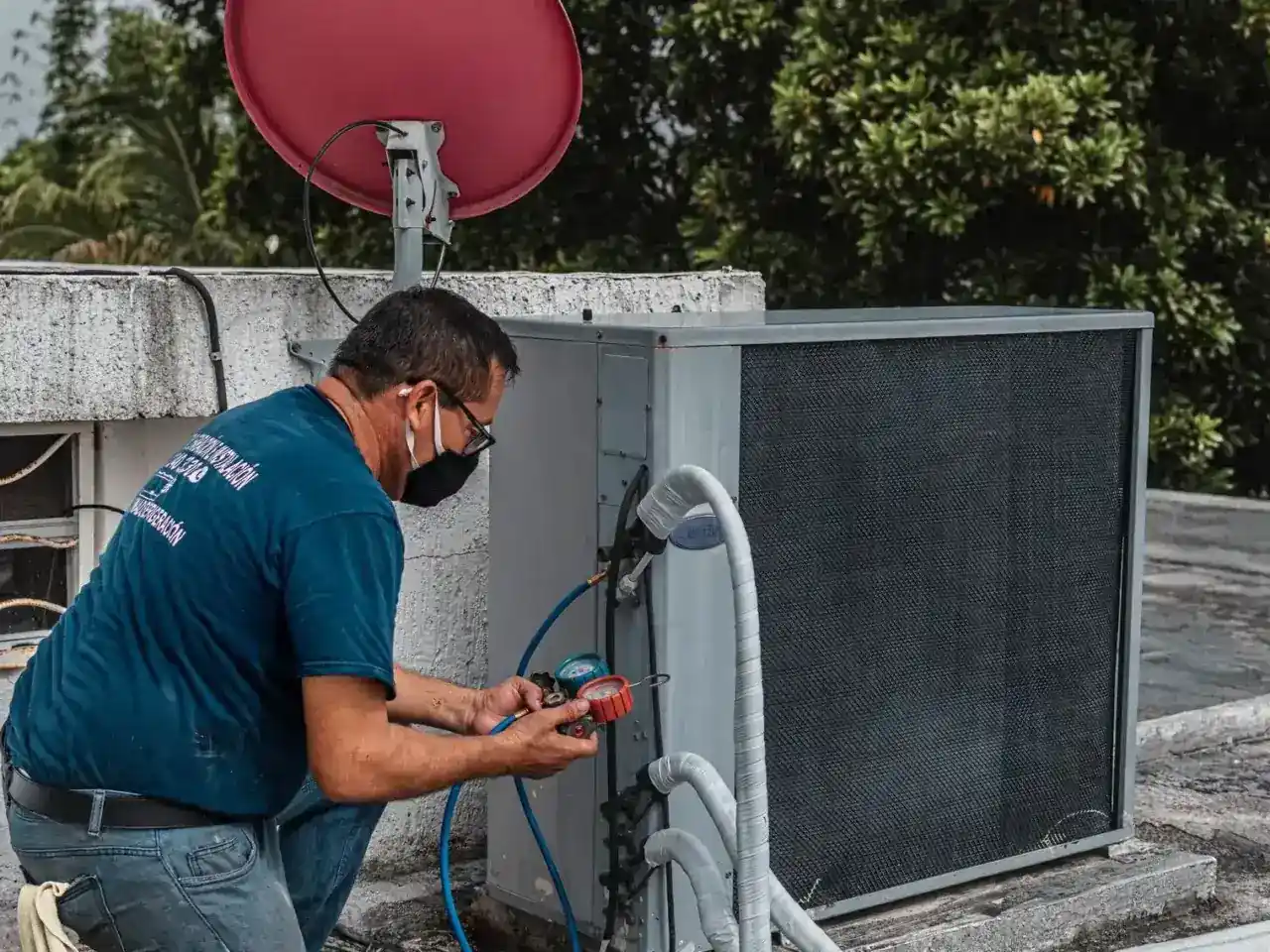 Hurricane HVAC technician servicing a rooftop air conditioning unit