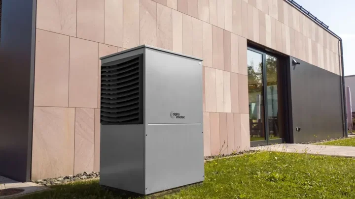 Modern heat pump unit installed outdoors next to a building