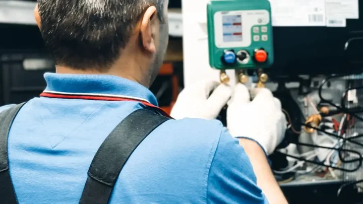 Technician working on HVAC system maintenance indoors